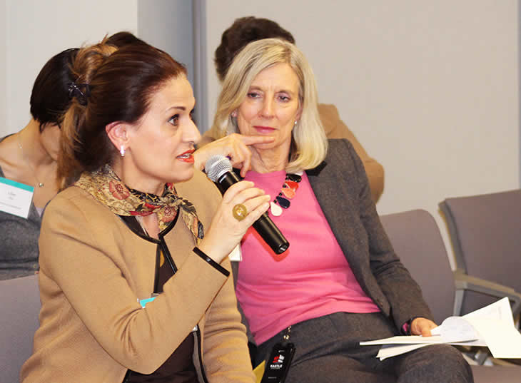 Photo of Sarak Clark watching a participant ask a question.