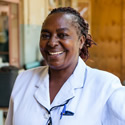 A Kenyan health worker smiles