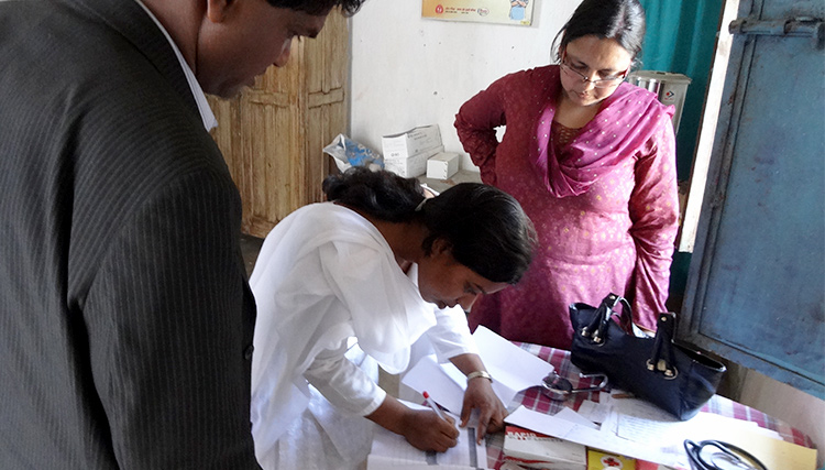 DPM Simdega visiting a sub center and checking records in Jharkand, India