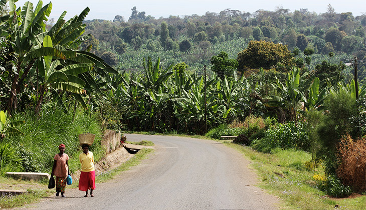 Two women carrying baskets down the road in Tanzania